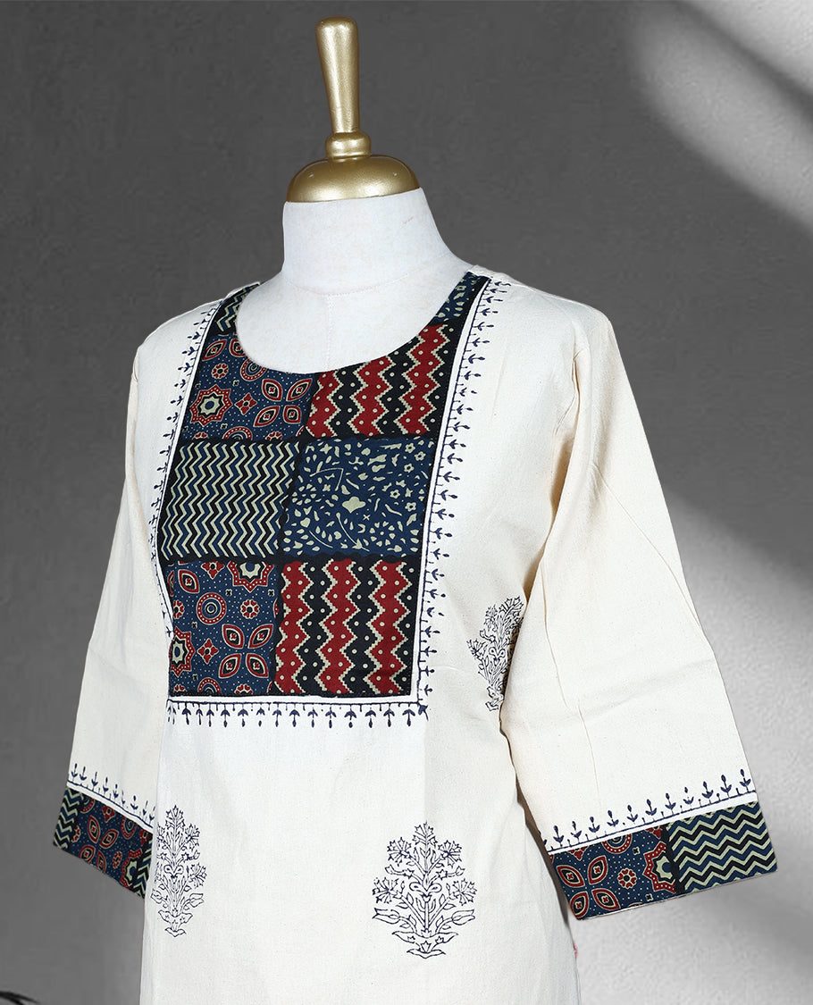 Cream colour cotton cord set with navy blue floral prints, highlighted by vibrant patchwork on the yoke and sleeve borders, Paired with matching straight pants.