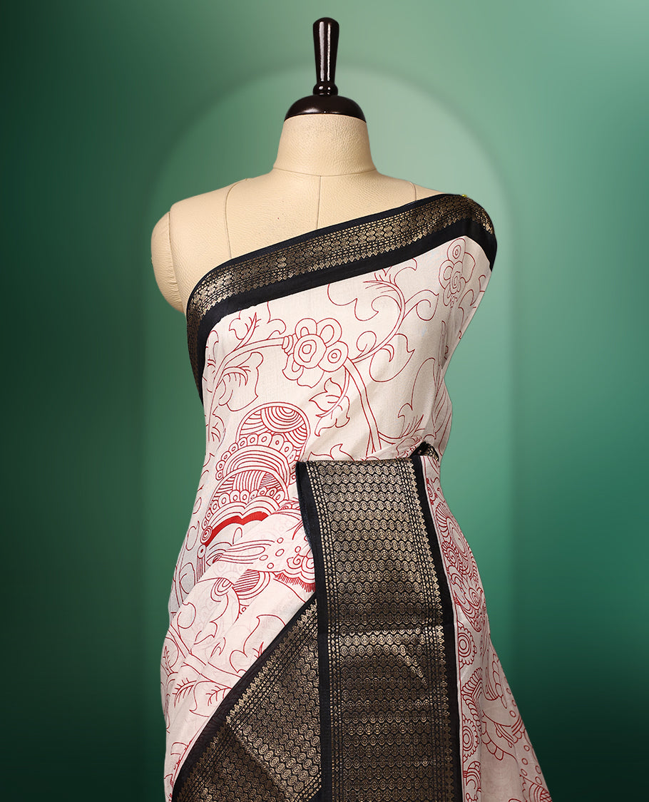 off white colour saree adorned with intricate red Kalamkari style motifs, complemented by a bold red pallu featuring traditional designs, and finished with a rich black woven border, paired with a matching blouse