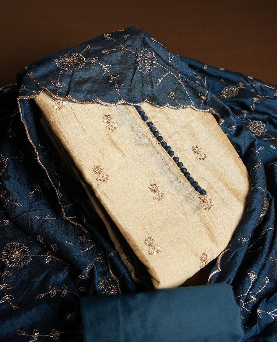 Golden Cream colour churidhar material featuring thread embroidery on the front panel, contrast Dark Teal colour dupatta with elegant border, and matching plain bottom