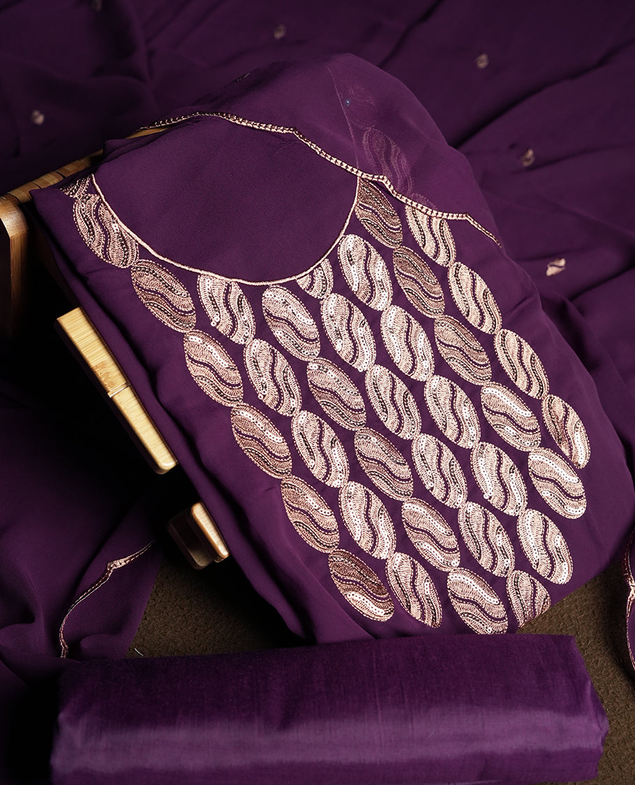 Dark violet colour churidar material adorned with intricate sequin embroidery on the neckline and body & Accompanied by a matching embroidered dupatta and plain bottom.