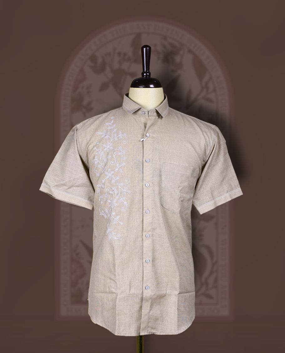 Taupe cotton linen short sleeve shirt featuring intricate white floral vine embroidery on the front, Designed with a mandarin collar and button-down style, blending artisanal detail with modern elegance.