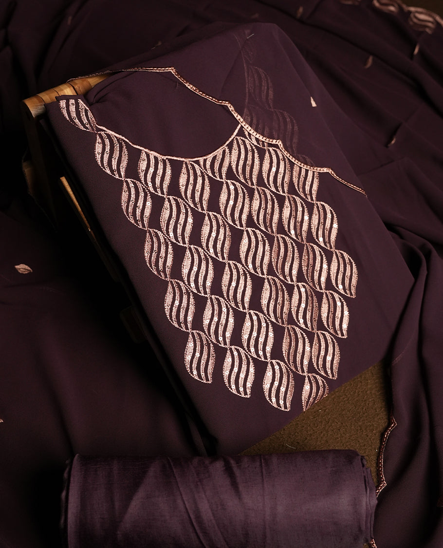 Dark Wine colour churidar material adorned with intricate sequin embroidery on the neckline and body & dupatta comes with embroidered motifs and matching scalloped embroidered border & and plain bottom.