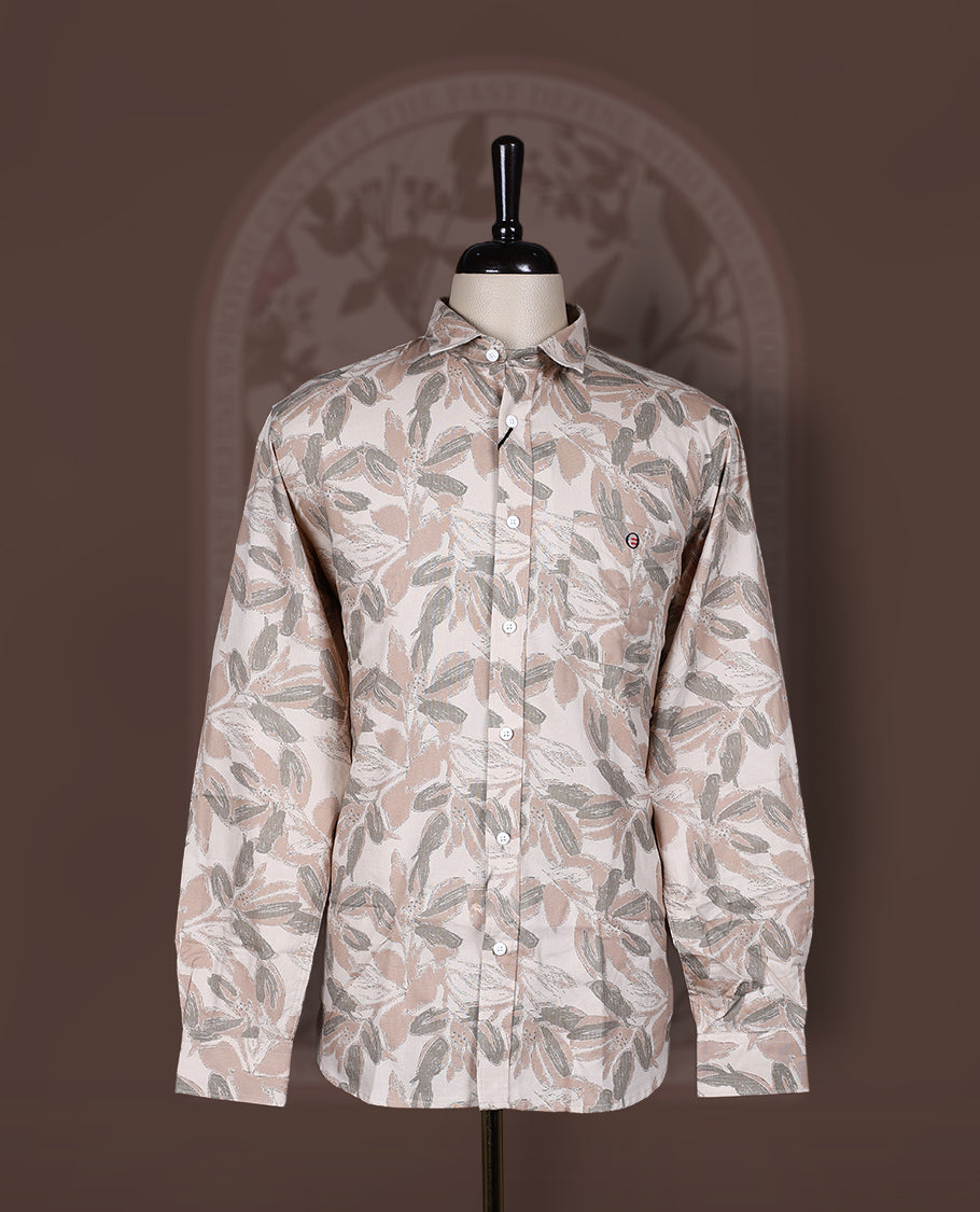 Cream colored shirt in soft cotton, featuring an all over leaf print in subtle earthy tones, Designed with a classic collar and roll up sleeves, it offers a perfect balance of tradition and ease.