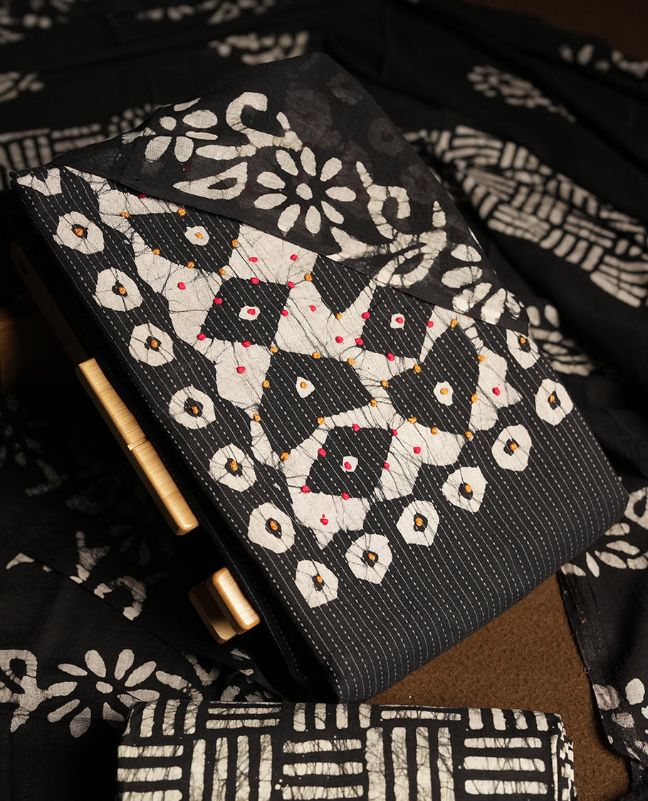 Black & Off white cotton churidar material adorned with thread work on the neckline, featuring traditional tie dye patterns and a stripped body & Comes with a matching printed dupatta and coordinated printed fabric for the bottom.