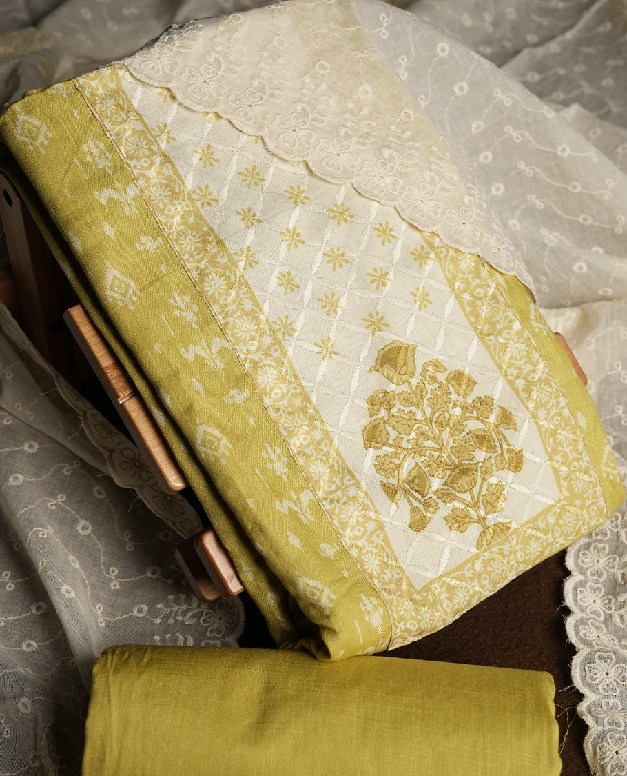 Pastel yellow and Off white cotton churidar material featuring elegant thread work on the neckline and floral prints on the body & Comes with an embroidered dupatta and matching plain bottom.