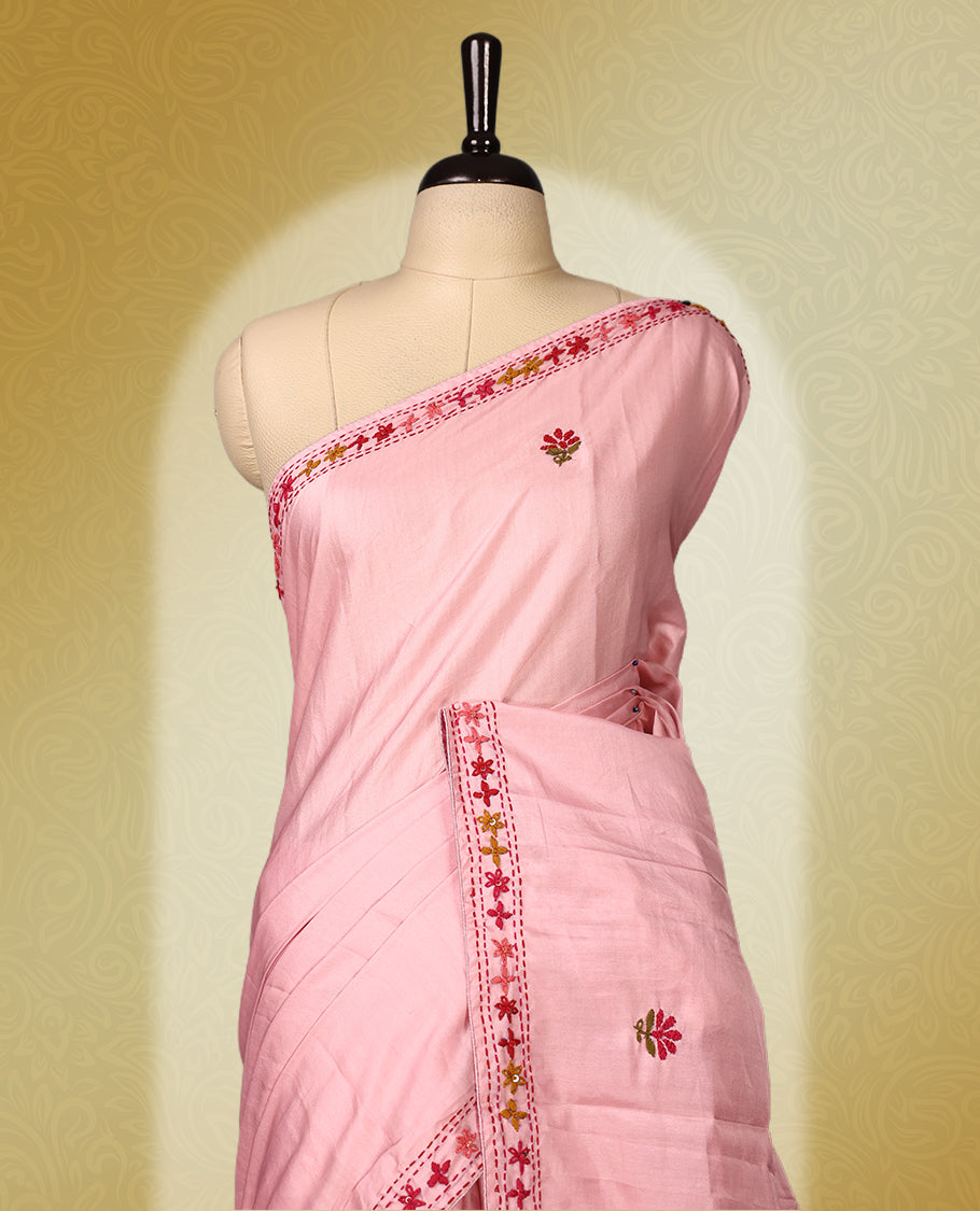Pink colour pure tussar saree adorned with delicate multicolour floral embroidery along the border and scattered motifs across the body, paired with a matching blouse.