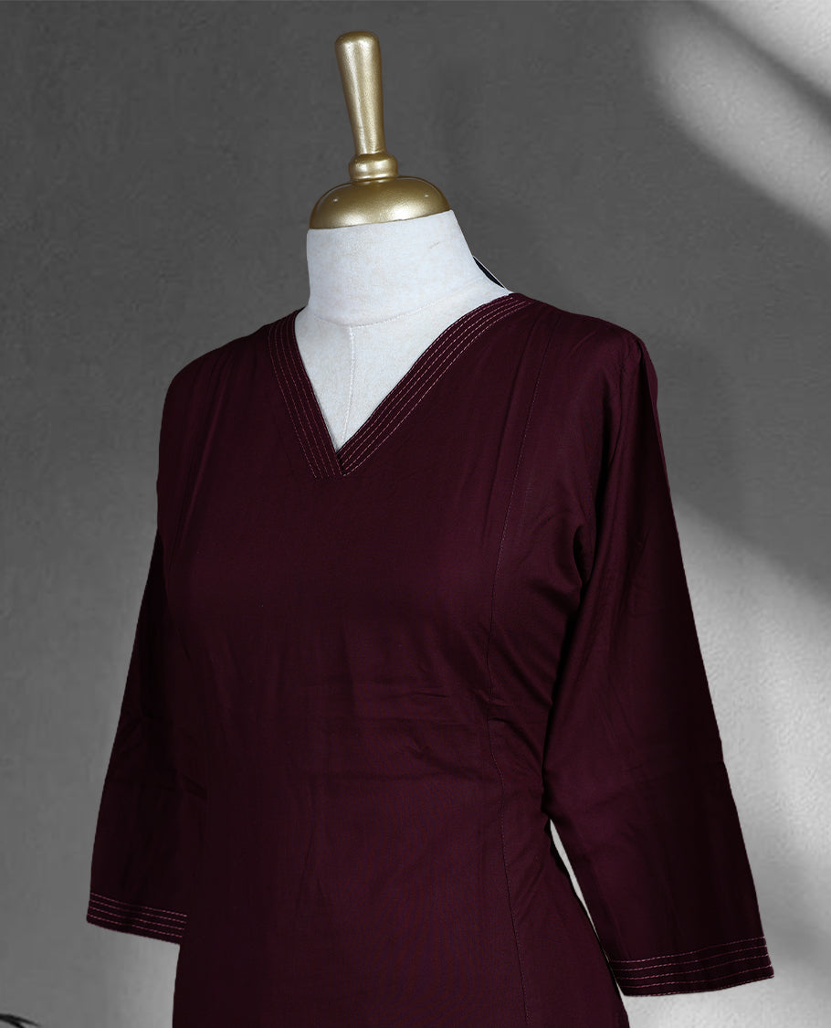 Dark grape colored cord set featuring a plain V neck kurta with subtle stitch detailing on neckline and sleeves, paired with matching palazzo.