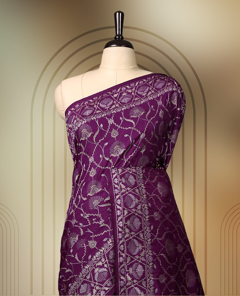 Rich purple Banaras soft silk saree with all over silver zari floral vines, ornate woven border, and bold pallu with paisley motifs. Comes with a matching blouse & Ideal for weddings and festive occasions.