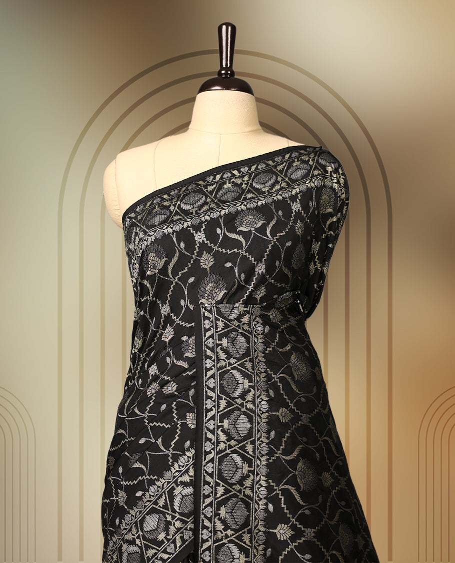 Classic black Banaras soft silk saree adorned with silver zari floral vines, detailed woven border, and grand paisley pallu, Comes with a matching blouse & A regal pick for festive and formal occasions.