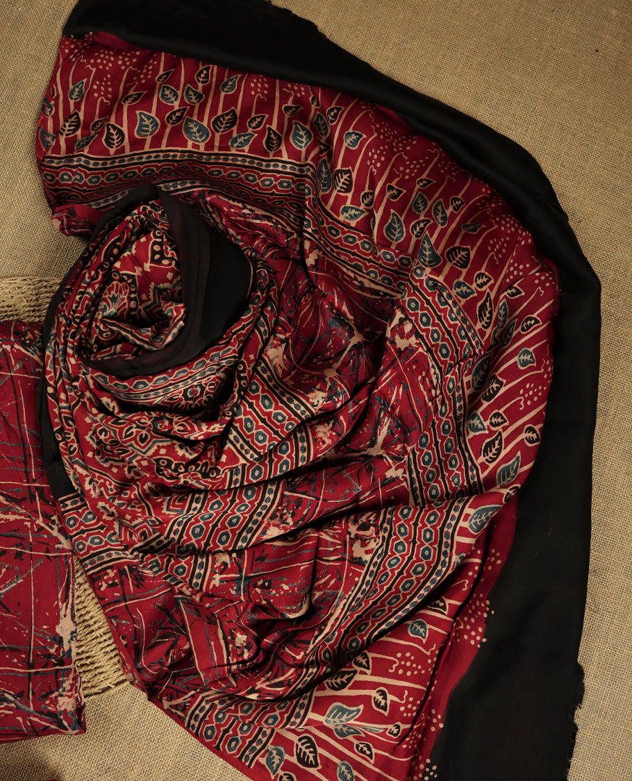 Deep maroon colour suit material featuring intricate hand block and batik inspired prints & Paired with a beautifully patterned dupatta and solid matching bottom.