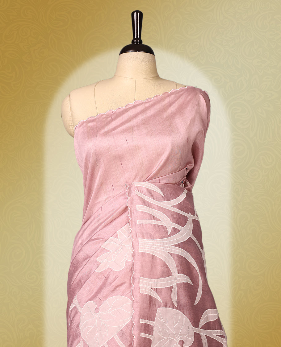 pink colour semi tussar saree featuring elegant white floral and leaf applique work along the body and border, paired with a matching blouse.