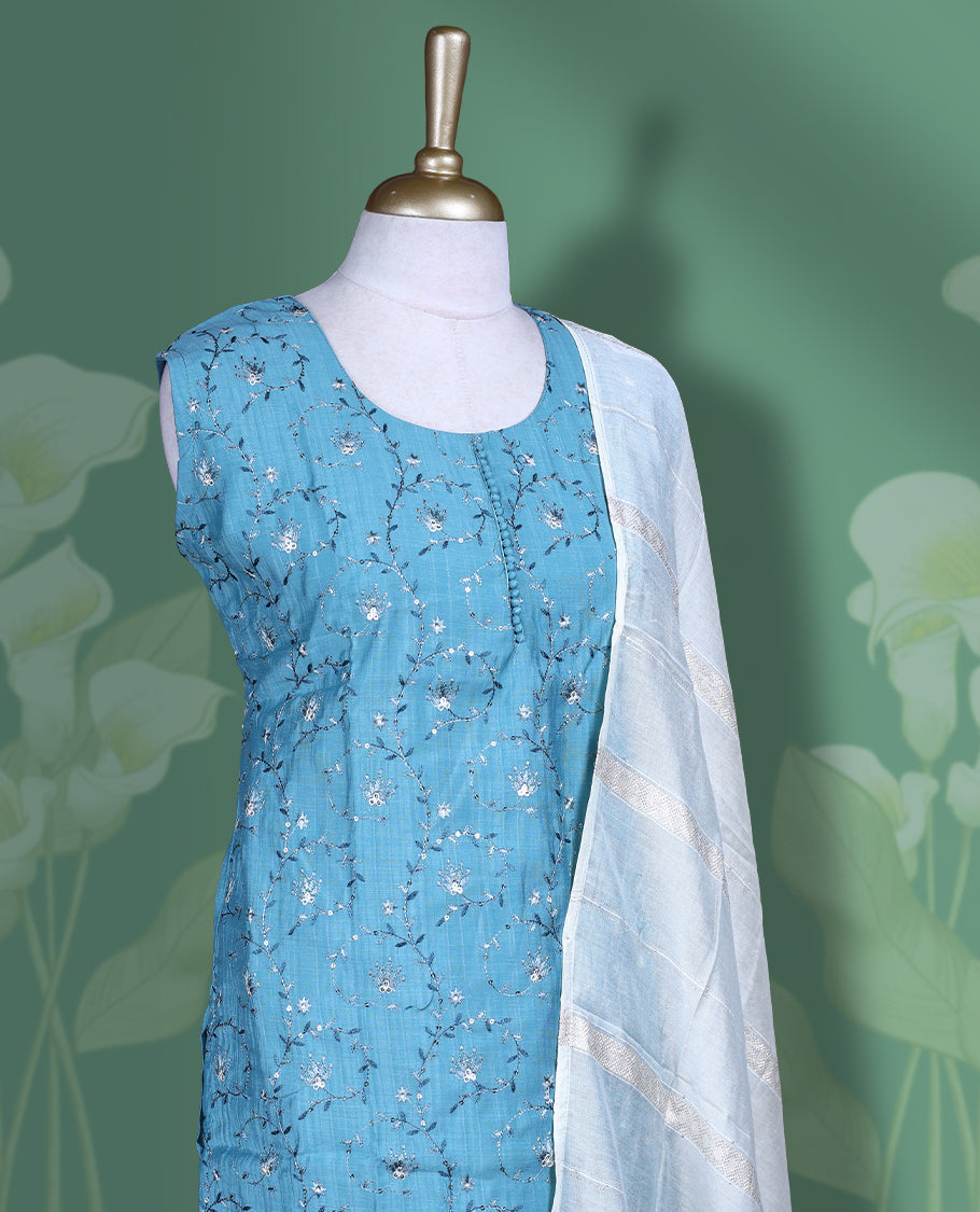 Blue colour churidar set featuring U neckline, sleeveless, and self colour and white colur floral kodi thread pattern across the body, Paired with a contrast white colour dupatta