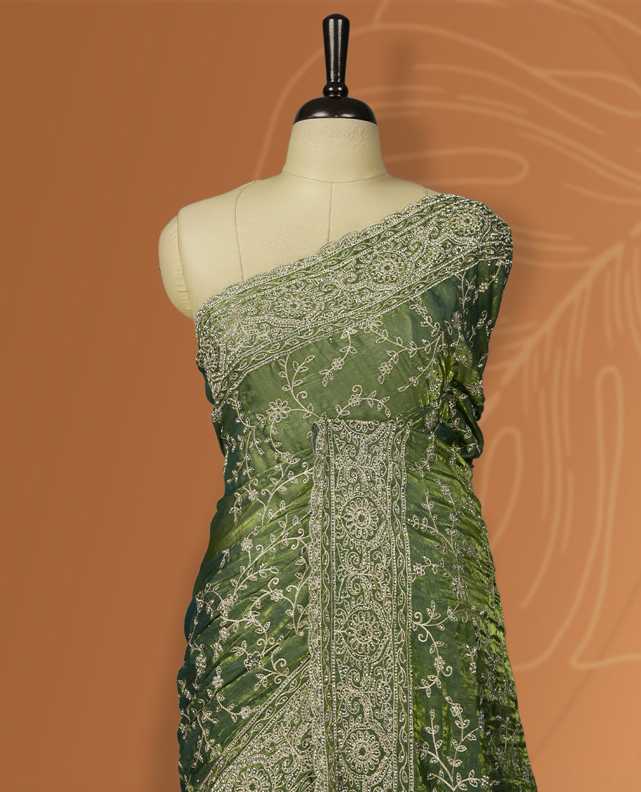 Pista green colour velvet chiffon designer saree in elegant two tone shades, featuring light gold zari, kodi work with handwoven style thread aari & dori embroidery work, Swarovski stone work and all over motifs, comes with matching blouse.