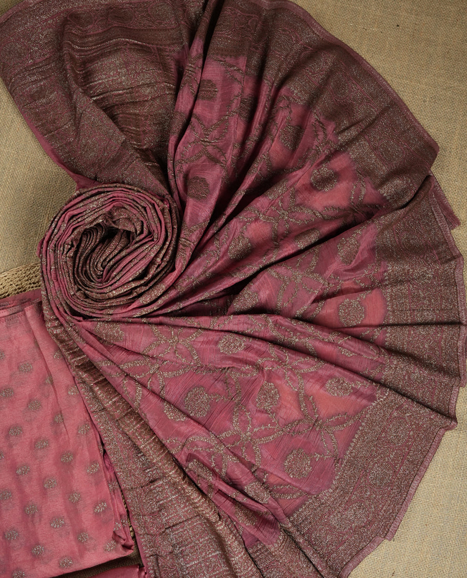 Dusty pink suit material adorned with delicate light copper toned zari work & Comes with a beautifully woven dupatta and matching plain bottom fabric.
