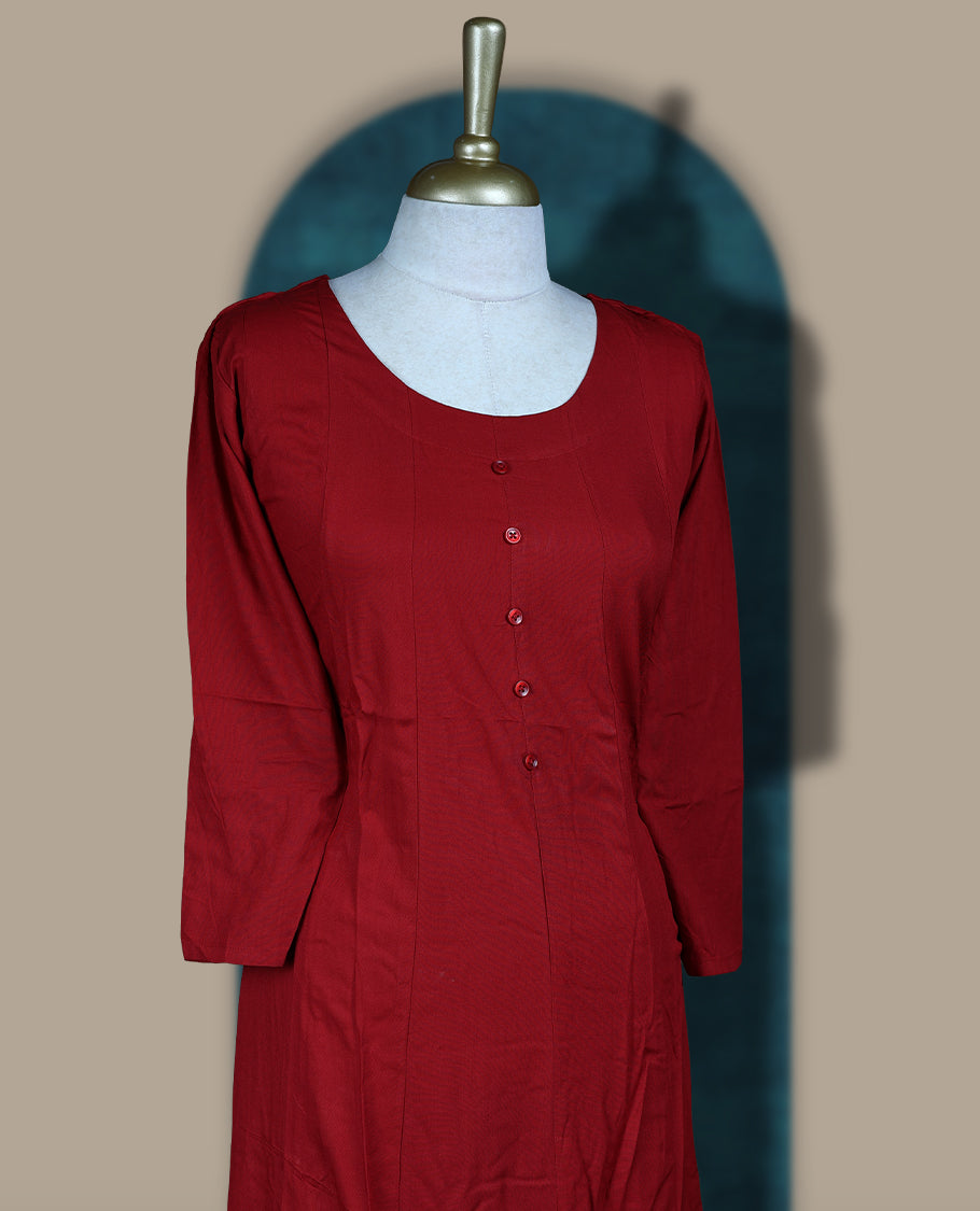 Maroon colour cotton kurthi with front buttons and 3/4th sleeves & Features a round neck and minimalist design for a classy everyday look, Ideal for work or casual wear with maximum comfort.