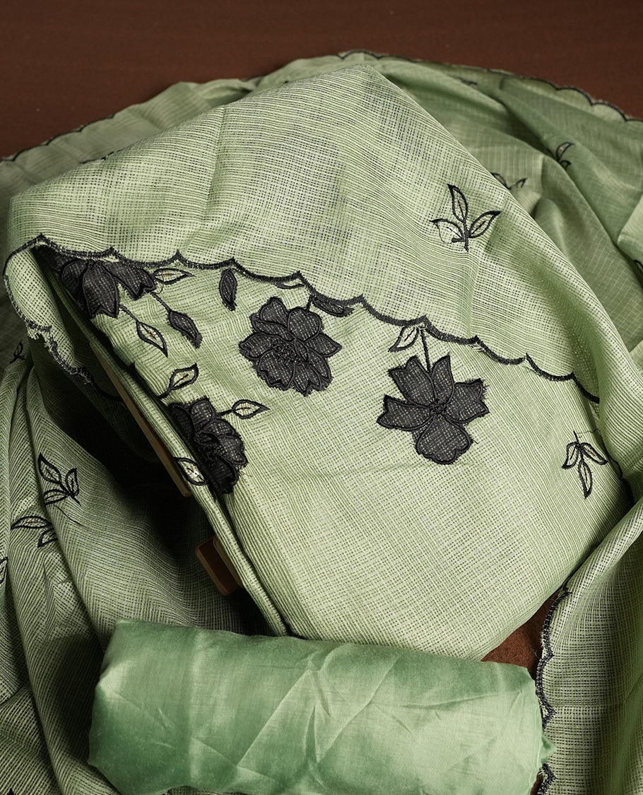 Green colour churidhar material featuring Black colour thread embroidery on the front panel, self colour dupatta with elegant border, and matching plain bottom