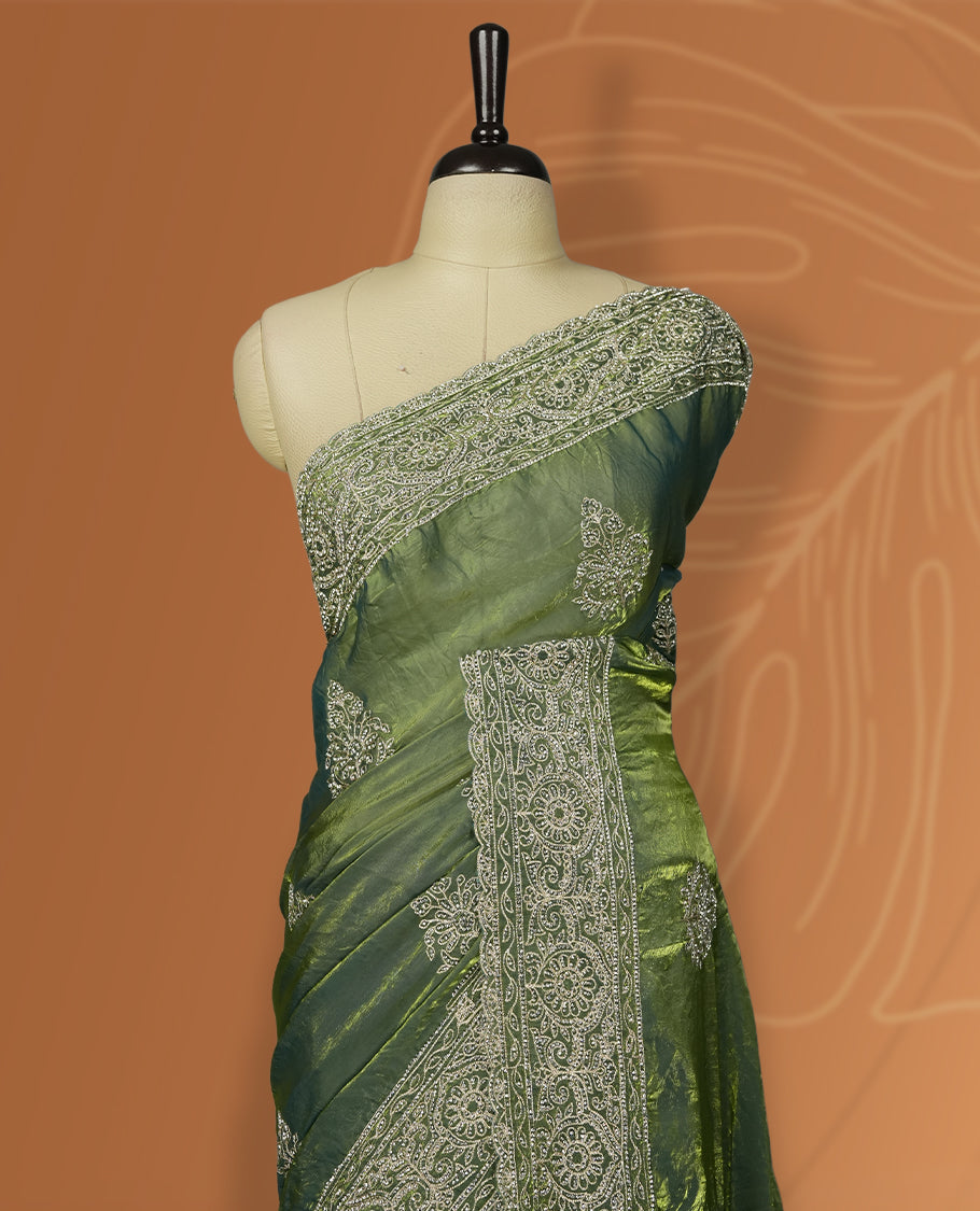 Asparagus green colour velvet chiffon designer saree in elegant two tone shades, featuring light gold zari, kodi work with handwoven style thread aari & dori embroidery work, Swarovski stone work and all over motifs, comes with matching blouse.