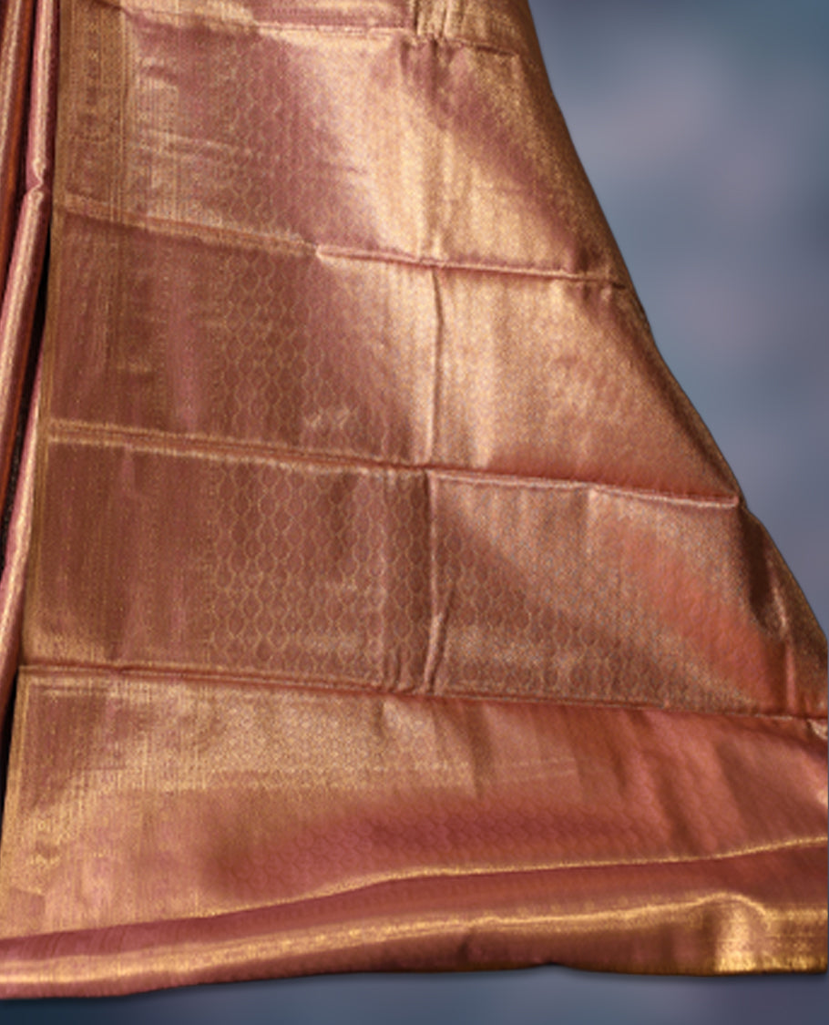Golden pink colour semi silk brocade saree featuring delicate self brocade motifs across the body, enhanced with a soft gold toned woven border and pallu, Includes a matching blouse for a graceful ethnic look.