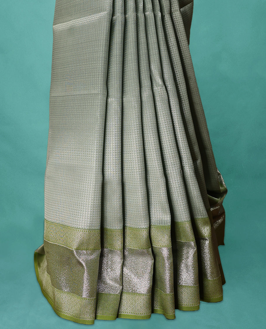 Greenish Grey coloured Art Soft Silk saree featuring a Check design on the body, paired with a Green coloured border and matching blouse.