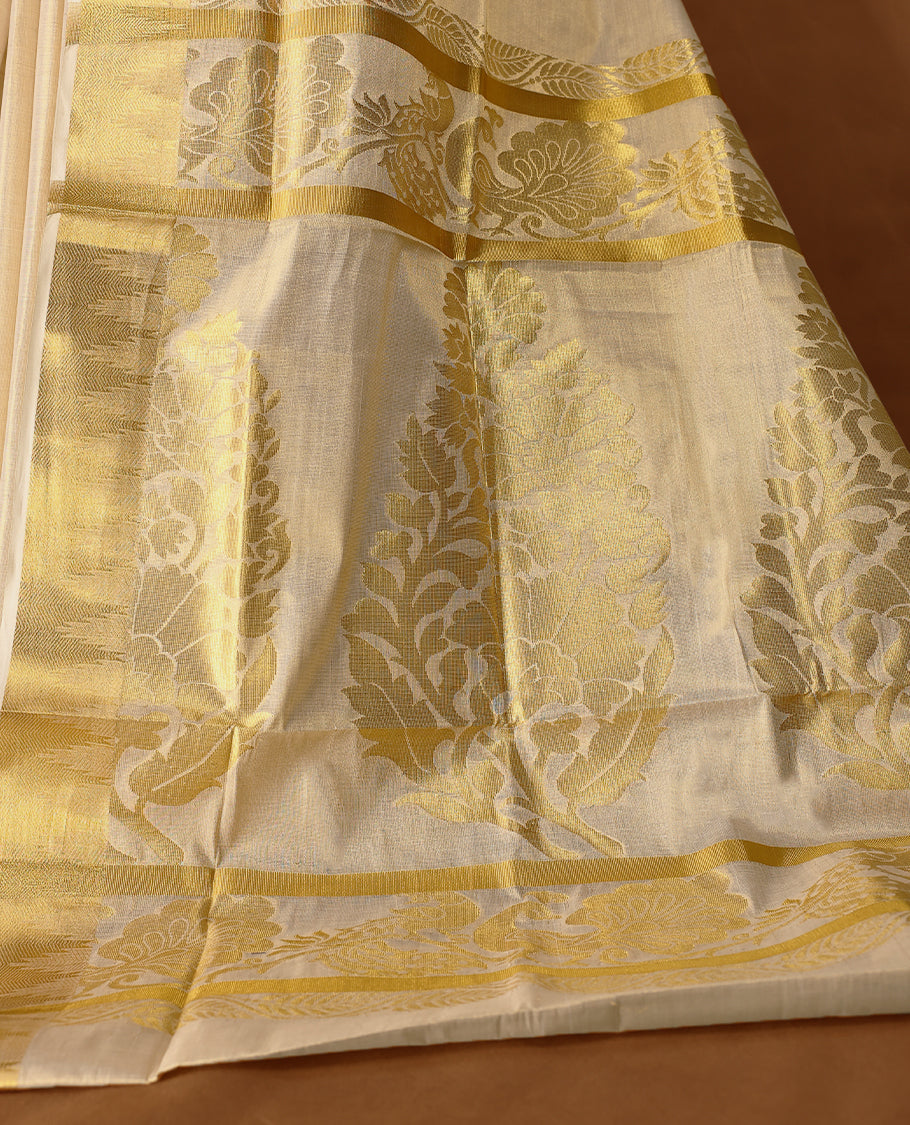 Elegant Light Gold colour Tissue Kerala saree featuring Flower Motifs on body, traditional golden zari kasavu border & Rich Pallu offering a classic and graceful look, paired with a matching blouse.