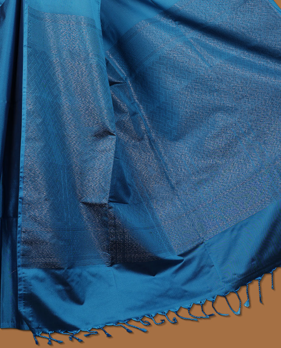 Ocean Blue colour semi soft silk saree adorned with delicate woven floral in square motifs on the body, complemented by a Self colour woven pallu with intricate detailing and tassel accents without border & Comes with a matching blouse piece.