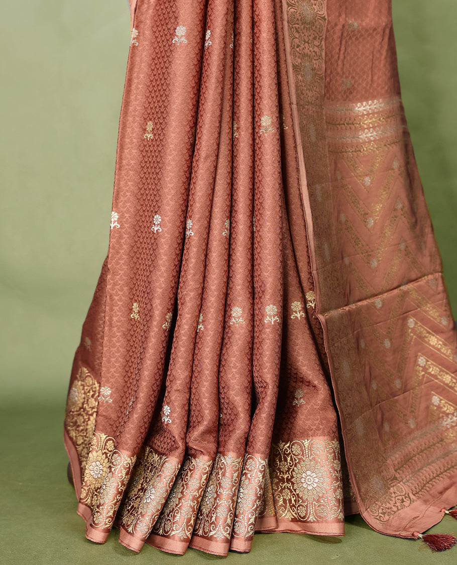Deep Pastel Brown colour pure Banaras crepe saree showcases elegant silver zari Flower Motifs all over the body, a traditional Banarasi gold zari border, a rich intricately woven pallu, and comes with a matching blouse.