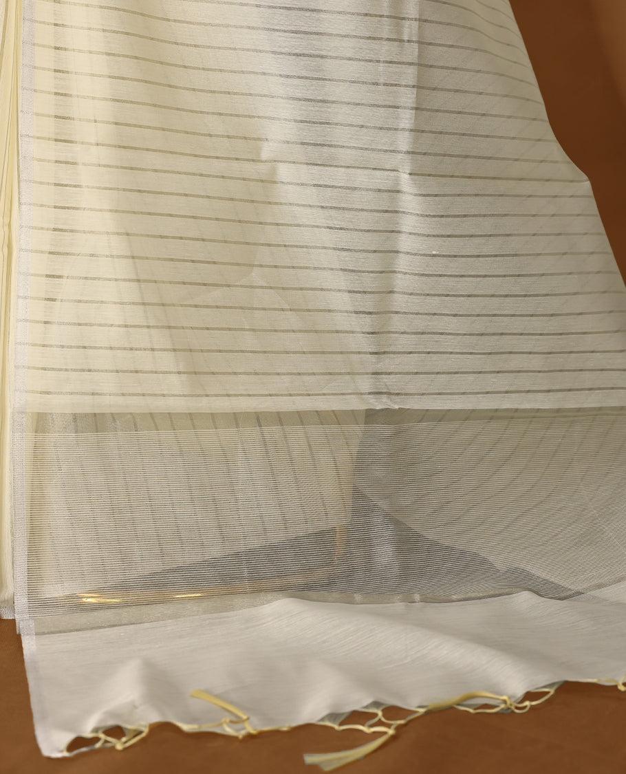 Light gold colour Organza Kerala saree featuring Silver zari stripes on the body, without border, Comes paired with a coordinated matching blouse.