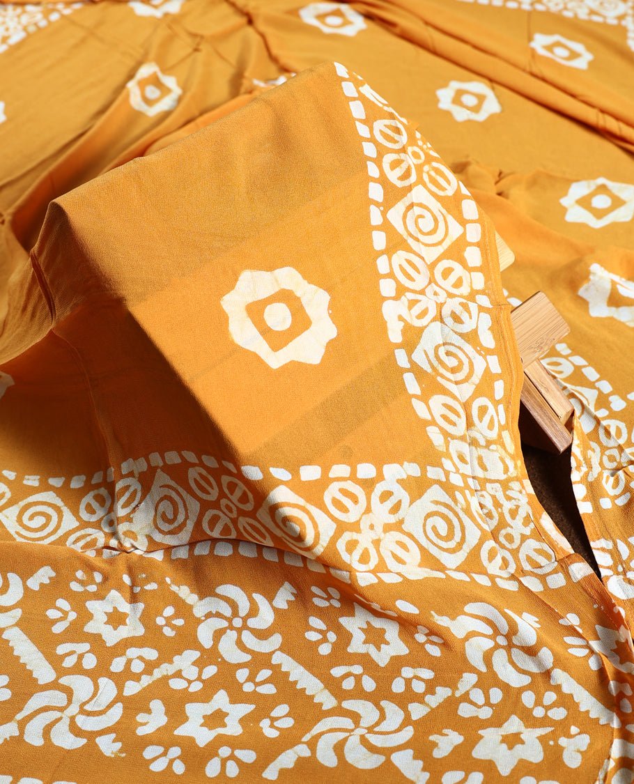 Deep yellow colour churidhar material featuring delicate floral patterns with gold highlights and bold block designs, paired with a plain matching bottom and vibrant dupatta.