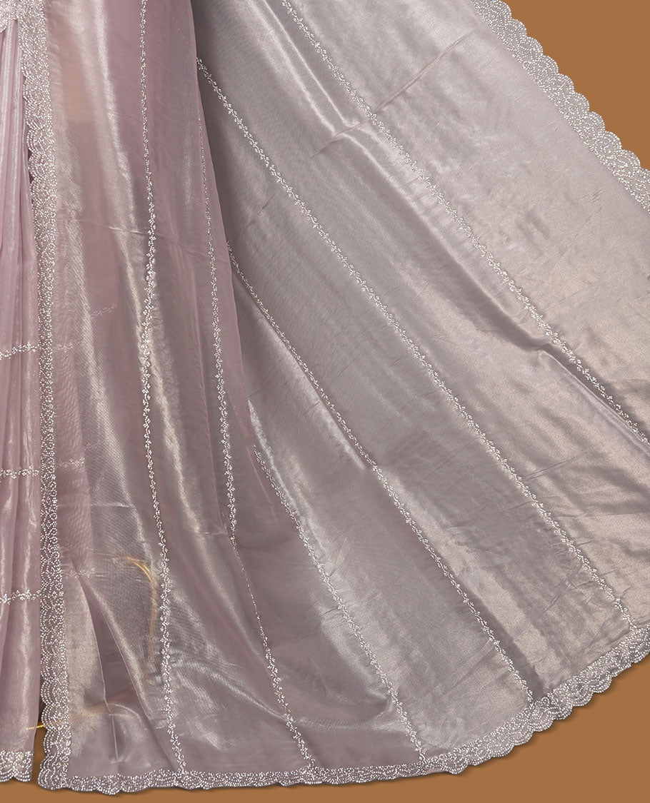 Light lavender colour net shimmer fancy saree adorned with scattered white stone buttas all over the body, paired with a delicate stone worked border and matching blouse.