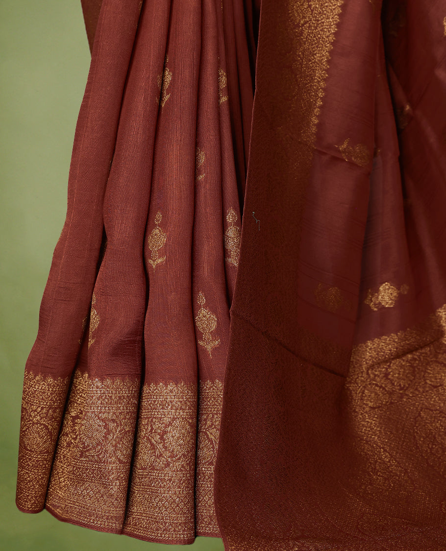 Rust Orange semi-Banaras tussar georgette saree embellished with antique zari motifs across the body, complemented by a rich heritage Banaras border and paired with a matching blouse.