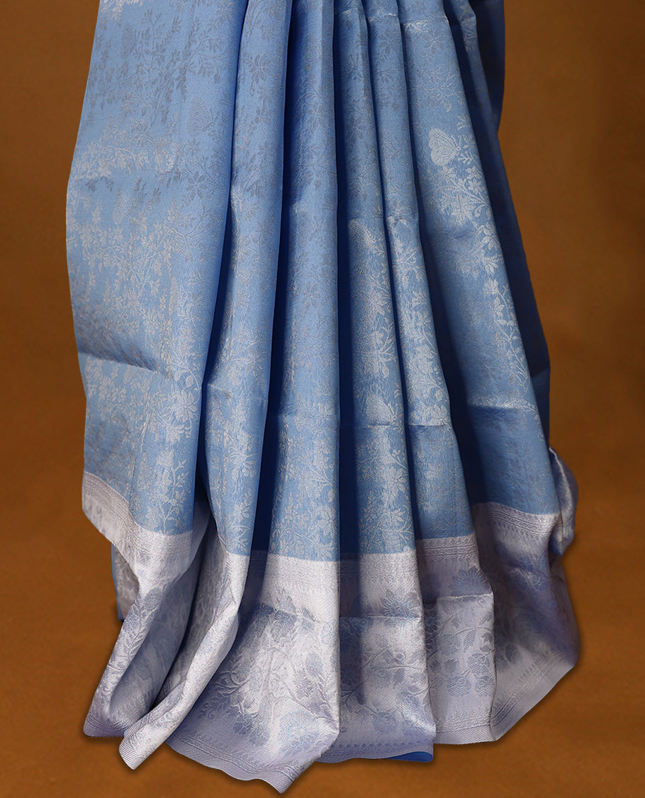 Pastel Blue coloured semi silk saree featuring a Silver coloured Zari design on the body, paired with a Baby Blue coloured border and matching blouse.