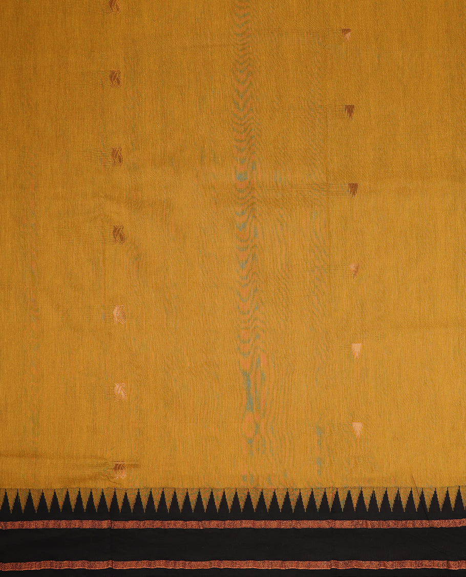 Mustard colour mixed Kalyani cotton saree featuring gold zari motifs throughout the body, paired with a Black colour traditional border and pallu, with matching blouse
