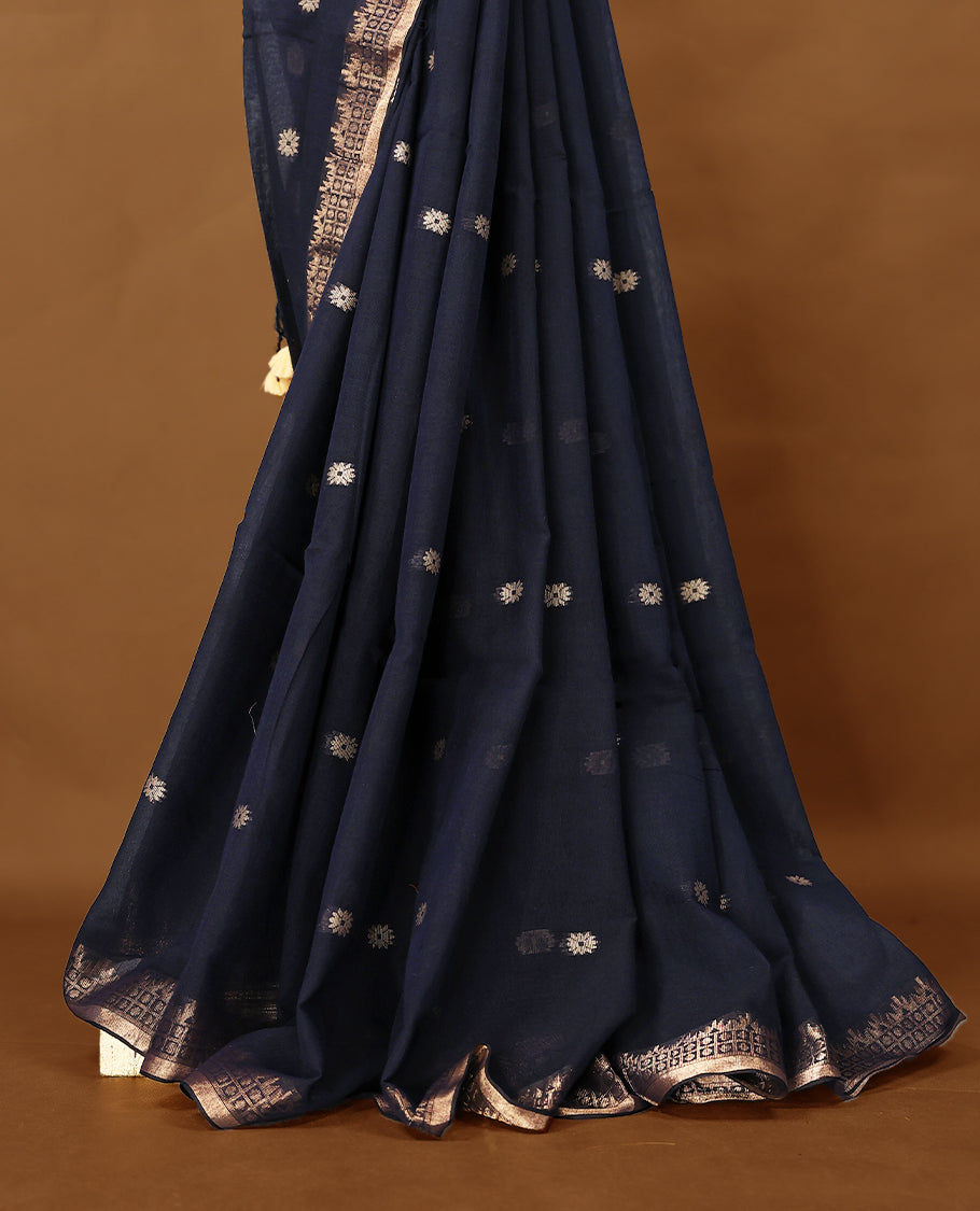 Deep Navy blue colour soft khadi cotton saree with small Beige Zari Flower motifs on the body, detailed woven Gold zari border, paired pallu with tussles, with matching blouse.