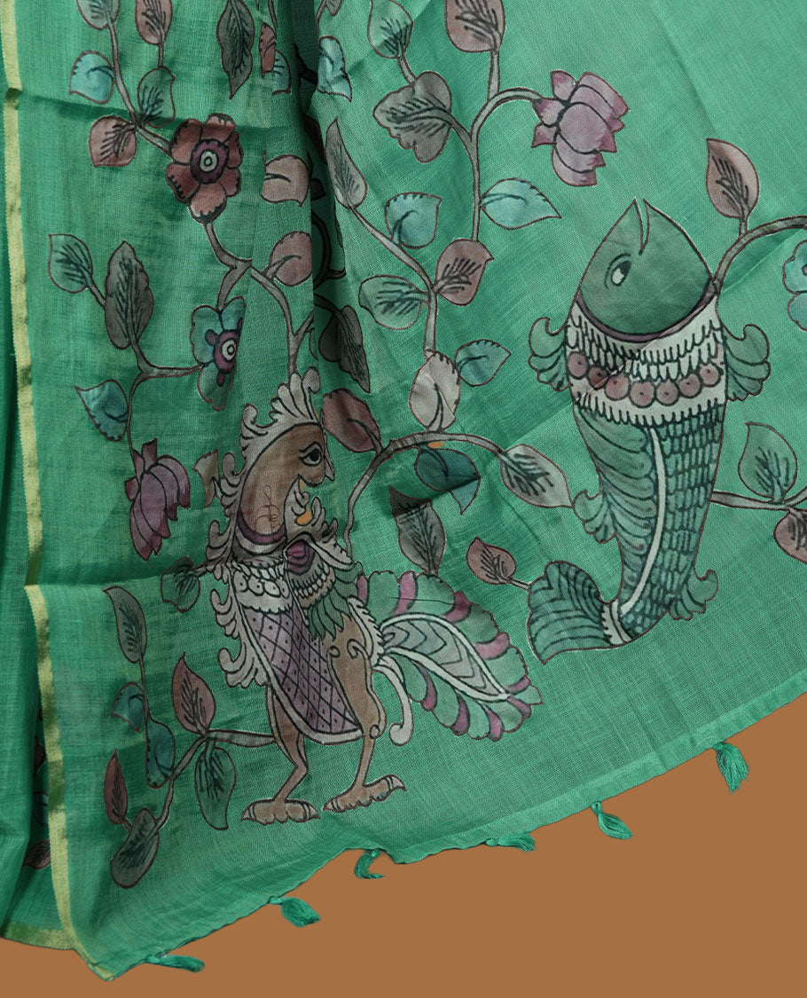 Mint green semi linen saree featuring hand painted floral and bird motifs across the pallu and border finished with subtle tassel detailing and paired with a matching floral print blouse