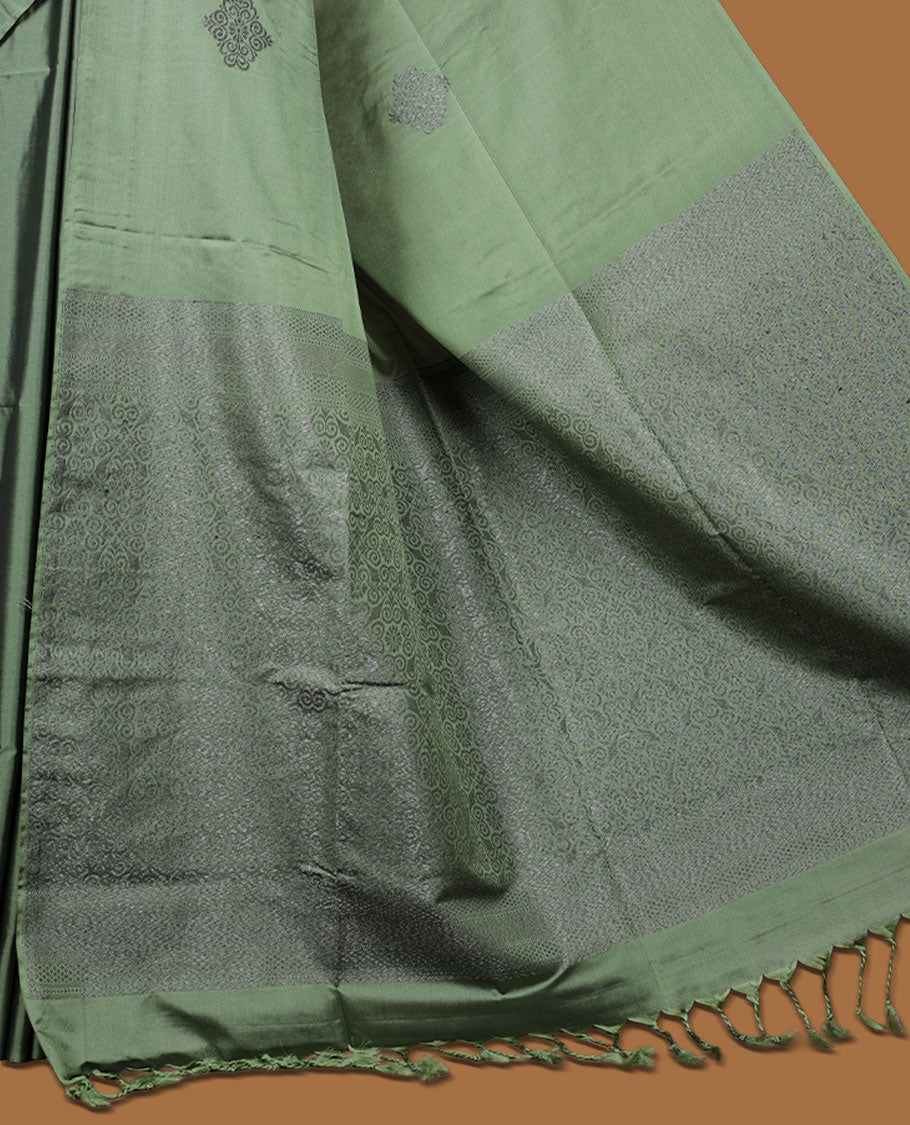Maple green colour semi soft silk saree adorned with delicate woven motifs on the body, complemented by a Self colour woven pallu with intricate detailing and tassel accents without border & Comes with a matching blouse piece.