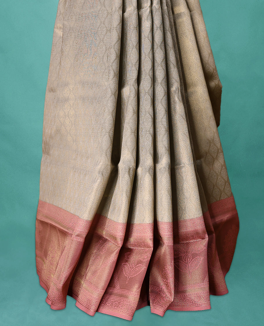Grey coloured semi silk saree featuring a Golden Brocade body, paired with a Pastel Onion coloured border and matching blouse.