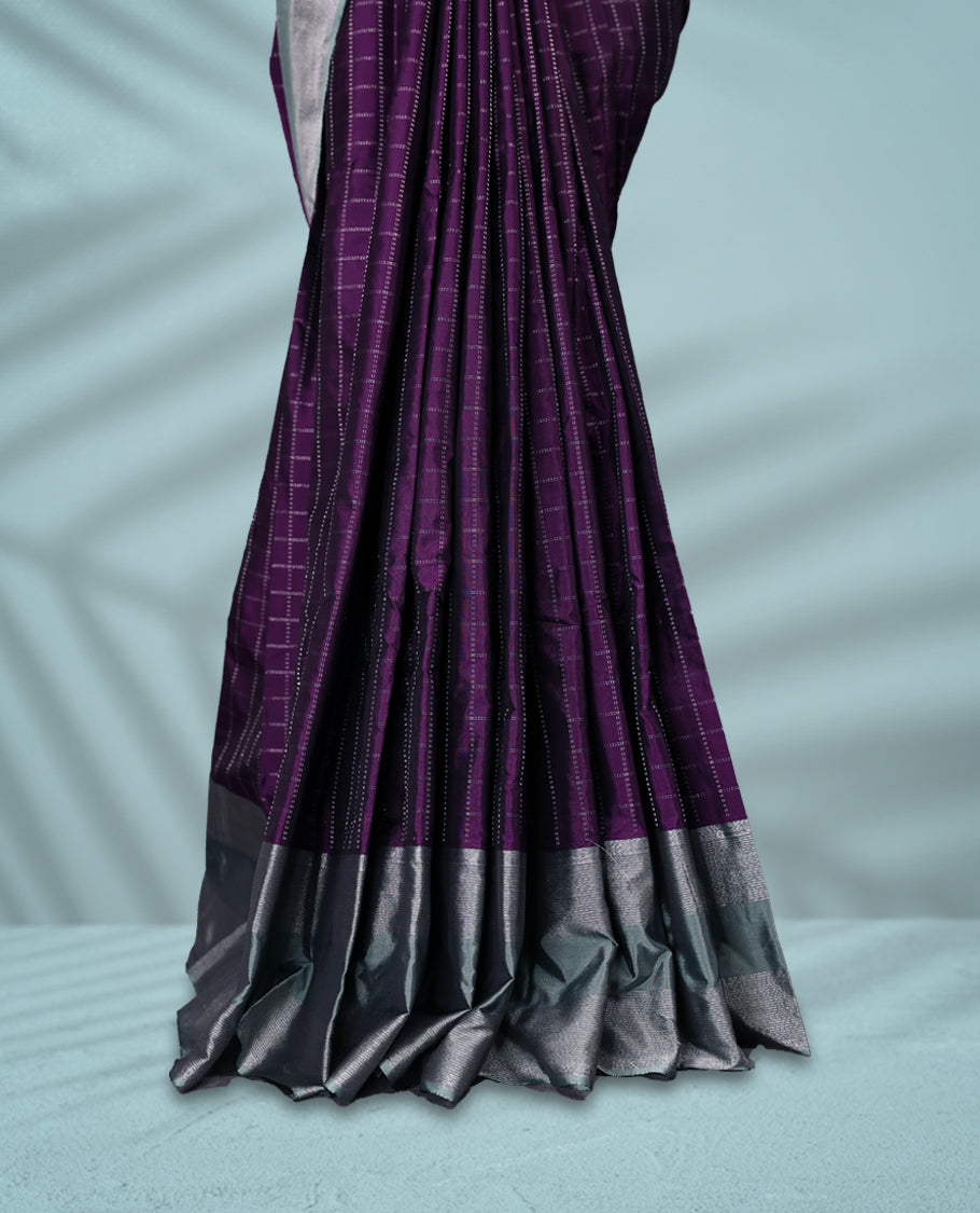 Regal purple Colour semi silk saree showcases a delicate silver zari check pattern, paired beautifully with a contrasting Ash Green border and a matching blouse