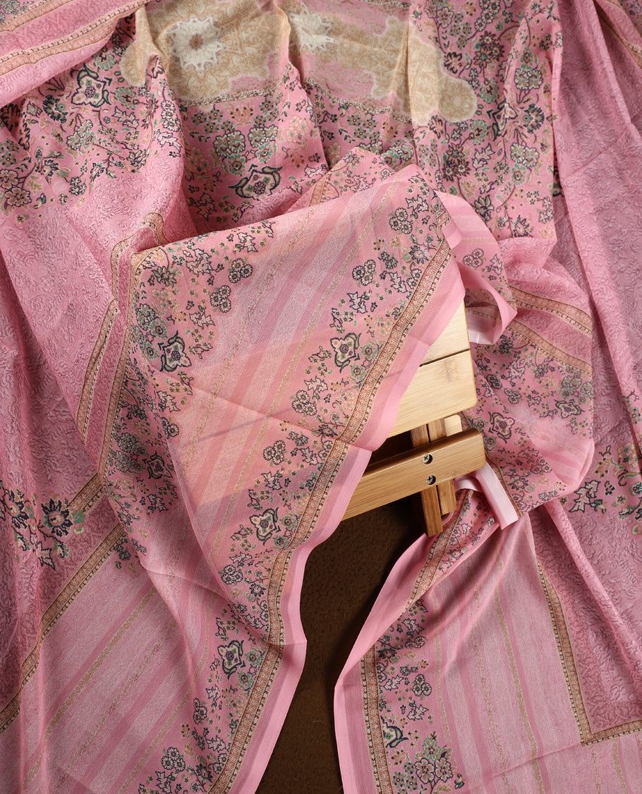 Pink colour churidhar material featuring delicate floral prints and intricate embroidery on the neckline, paired with a matching printed dupatta and a plain bottom.