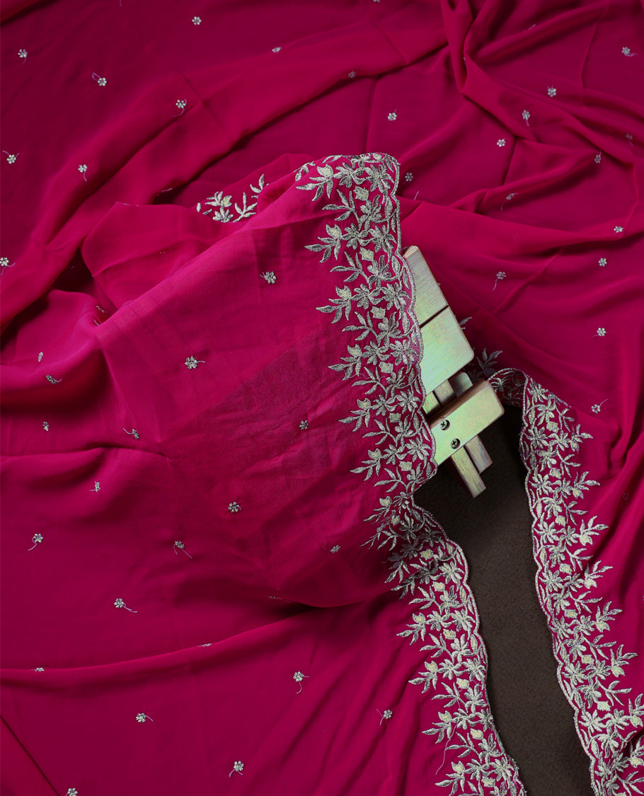 Pinkish red colour churidhar material adorned with elegant golden floral embroidery and delicate motifs, paired with a matching embroidered dupatta and plain bottom.