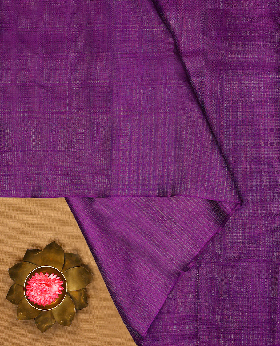 Violet coloured Manthrakodi saree featuring a multicoloured zari jacquard body, complemented by a self coloured turning Banarasi border and a matching self coloured blouse.