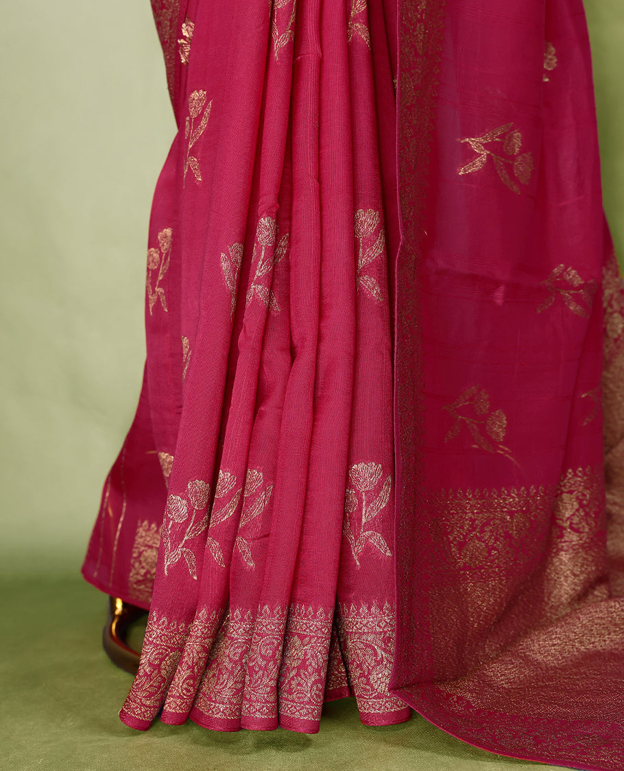 Deep Magenta colour semi Banaras tussar georgette saree embellished with antique zari flower motifs across the body, complemented by a rich Banaras border and paired with a matching blouse.
