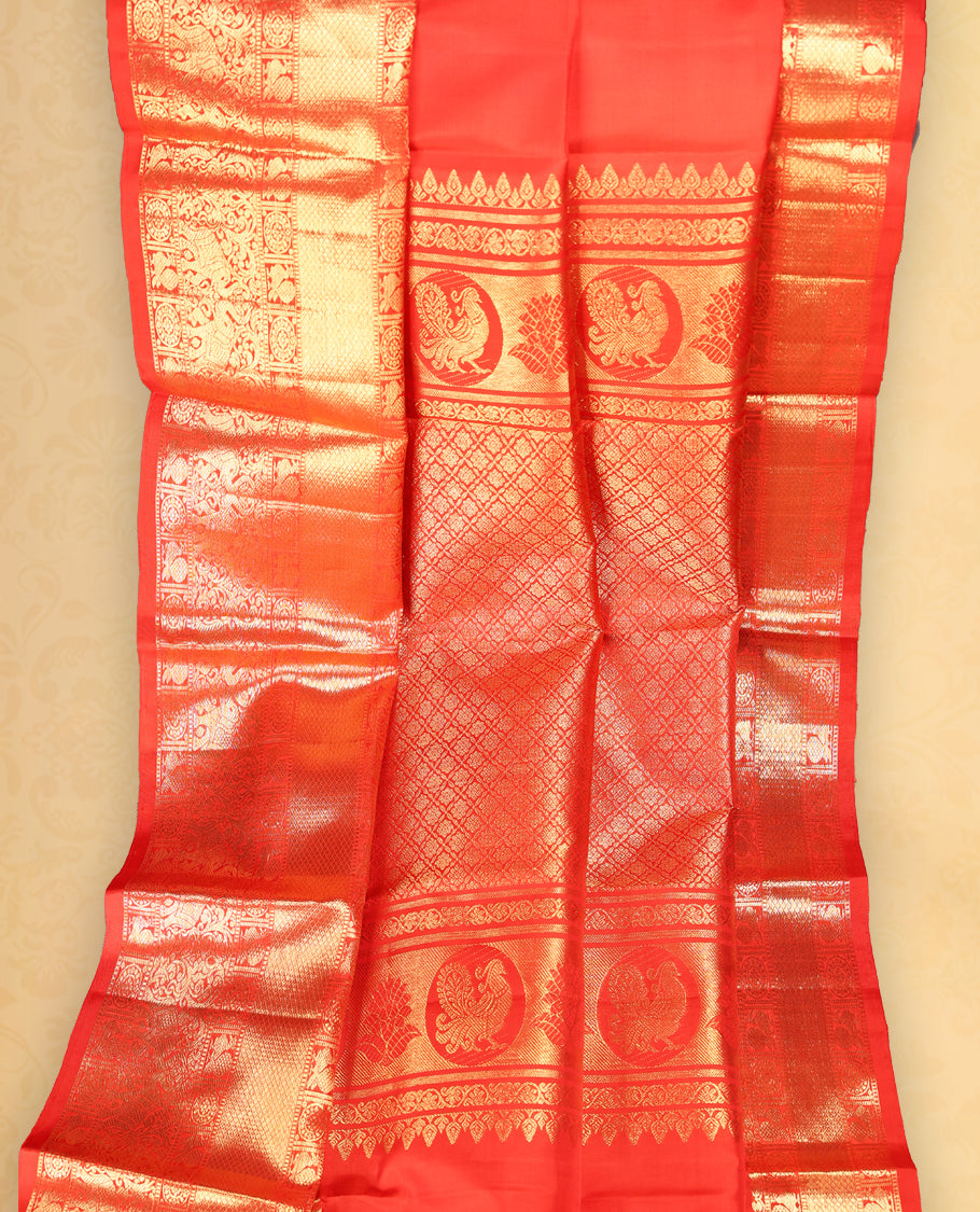 Red colour pure Kancheepuram saree with gold zari Banarasi mango motifs on the body, traditional border with elephant, floral, peacock and chackram motifs grand pallu with peacock and chackra pattern paired with matching blouse