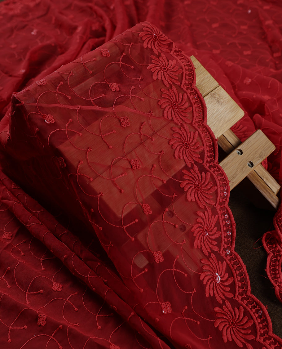 Stunning deep red churidhar material embellished with intricate floral embroidery and subtle sequin detailing, paired with a plain matching bottom and beautifully embroidered dupatta, ideal for festive and grand occasions.