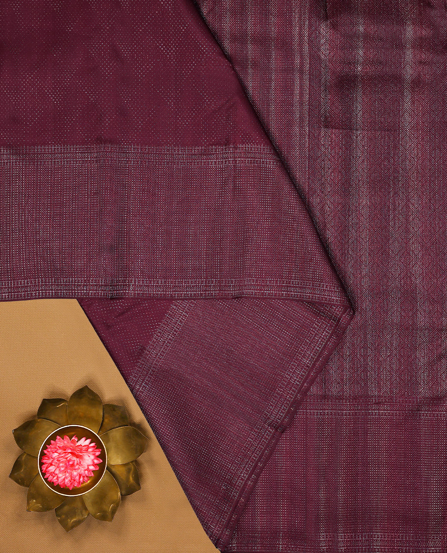 Dark Maroon coloured Manthrakodi saree featuring a multicoloured zari jacquard body, complemented by a self coloured turning Banarasi border and a matching self coloured blouse.