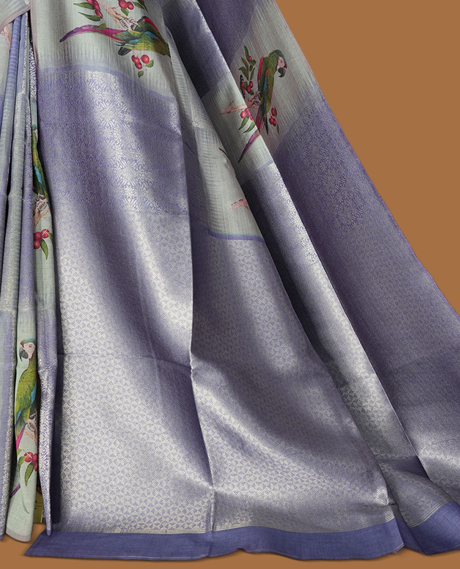 Gray Blue colour semi tussar Banarasi saree featuring printed parrot and floral motifs, gray blue zari border, and a matching blouse with woven accents.