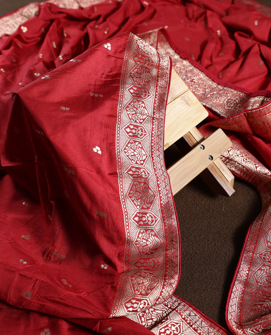 Reddish Brown churidhar material adorned with golden zari woven motifs and an elegant traditional border, paired with a plain matching bottom and grand dupatta, perfect for weddings, festive occasions, and celebrations.