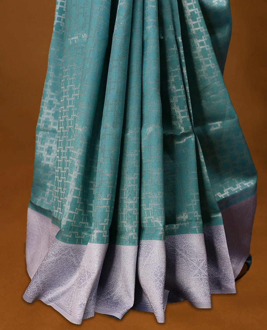 Aqua Green coloured semi silk saree featuring a Silver coloured Zari design on the body, paired with a Baby Blue coloured border and matching blouse.