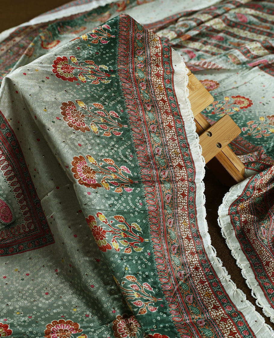 Cream colour churidhar material featuring intricate green colour traditional floral and block prints in red and gold, paired with a plain white bottom and a matching printed dupatta.