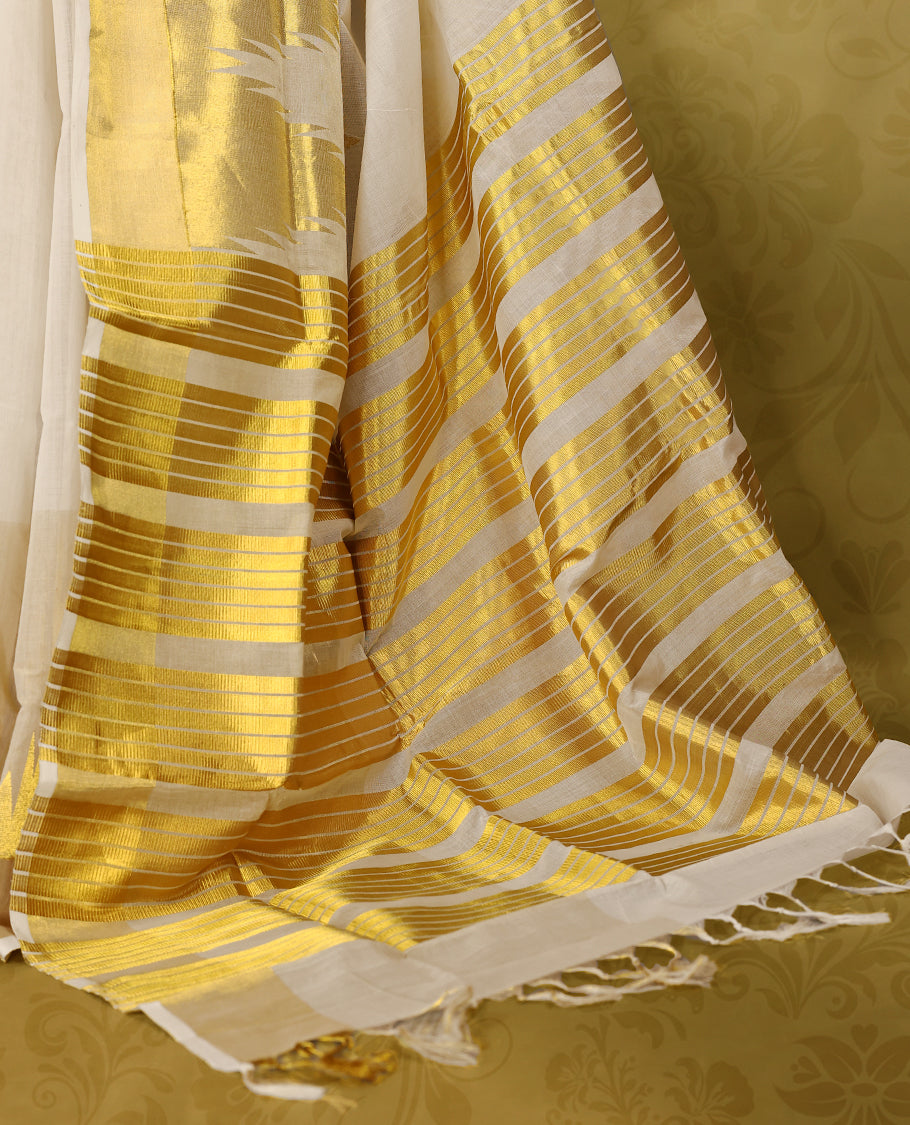 Off white colour pure narial handloom cotton saree with small gold zari motifs on body, golden zari border, pallu highlighted with bold golden zari stripes and abstract temple design, with matching blouse