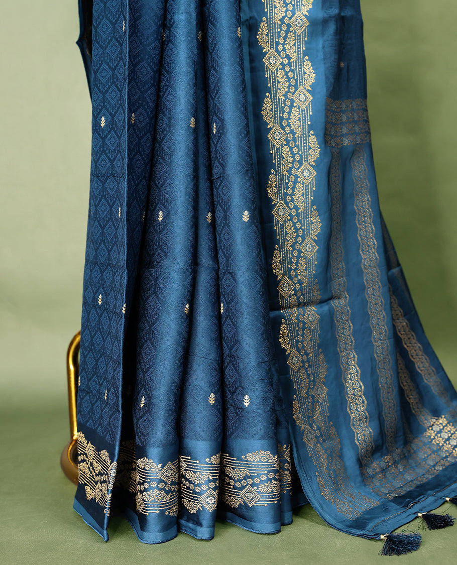 Peacock Blue colour pure Banaras crepe saree showcases elegant Gold & Silver zari Motifs all over the body, a traditional gold & Silver zari border, a rich intricately woven pallu, and comes with a matching blouse.